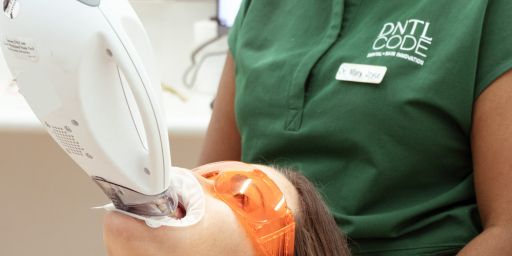 image of a girl doing her teeth treatment