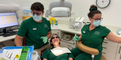 Dentist doing laser treatment of a girl