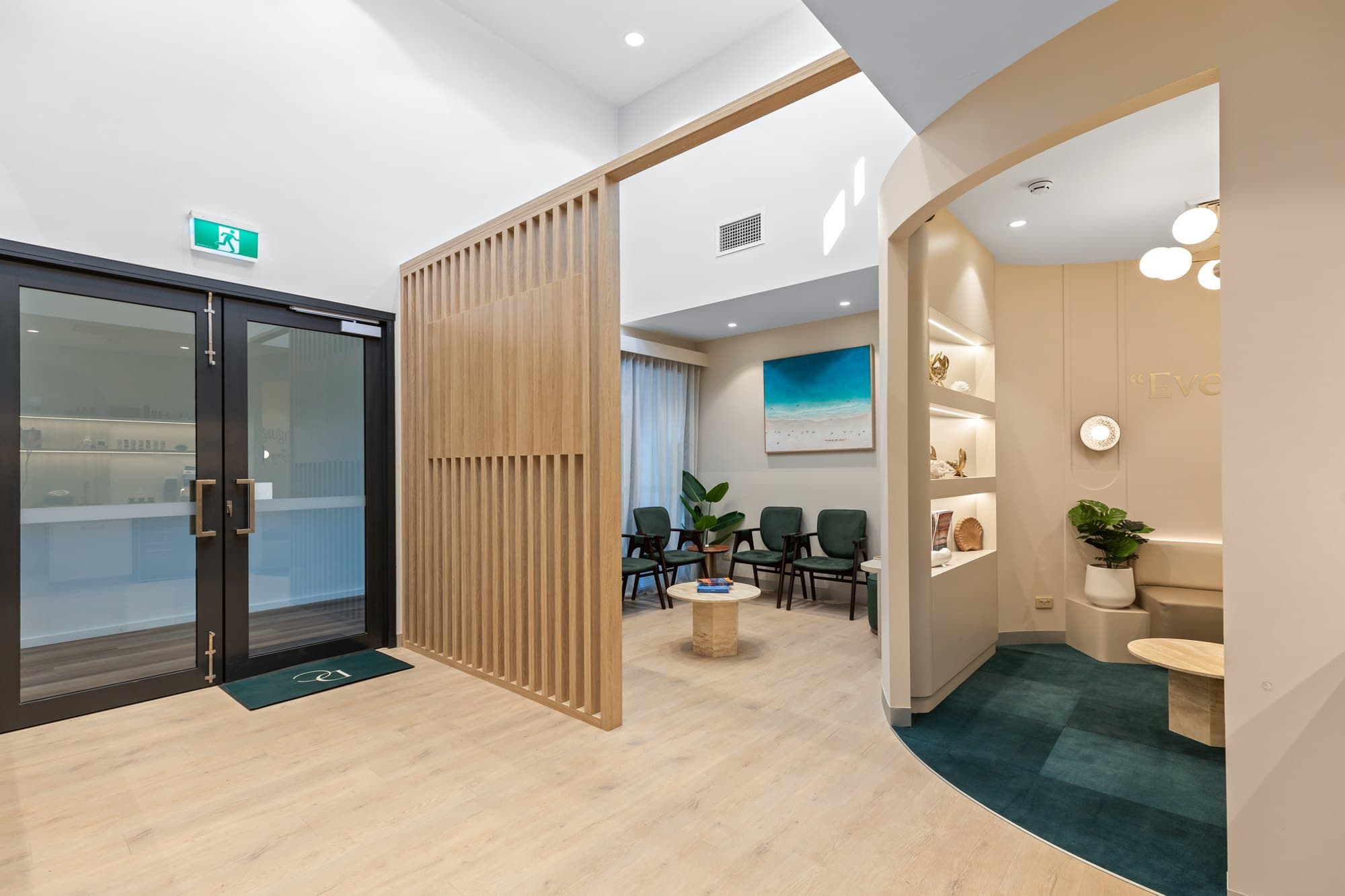 The waiting area and curved lounge with teal carpet