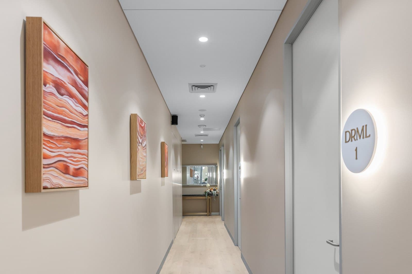 The hallway to the skin treatment rooms, lined with Bek Treacy’s artworks