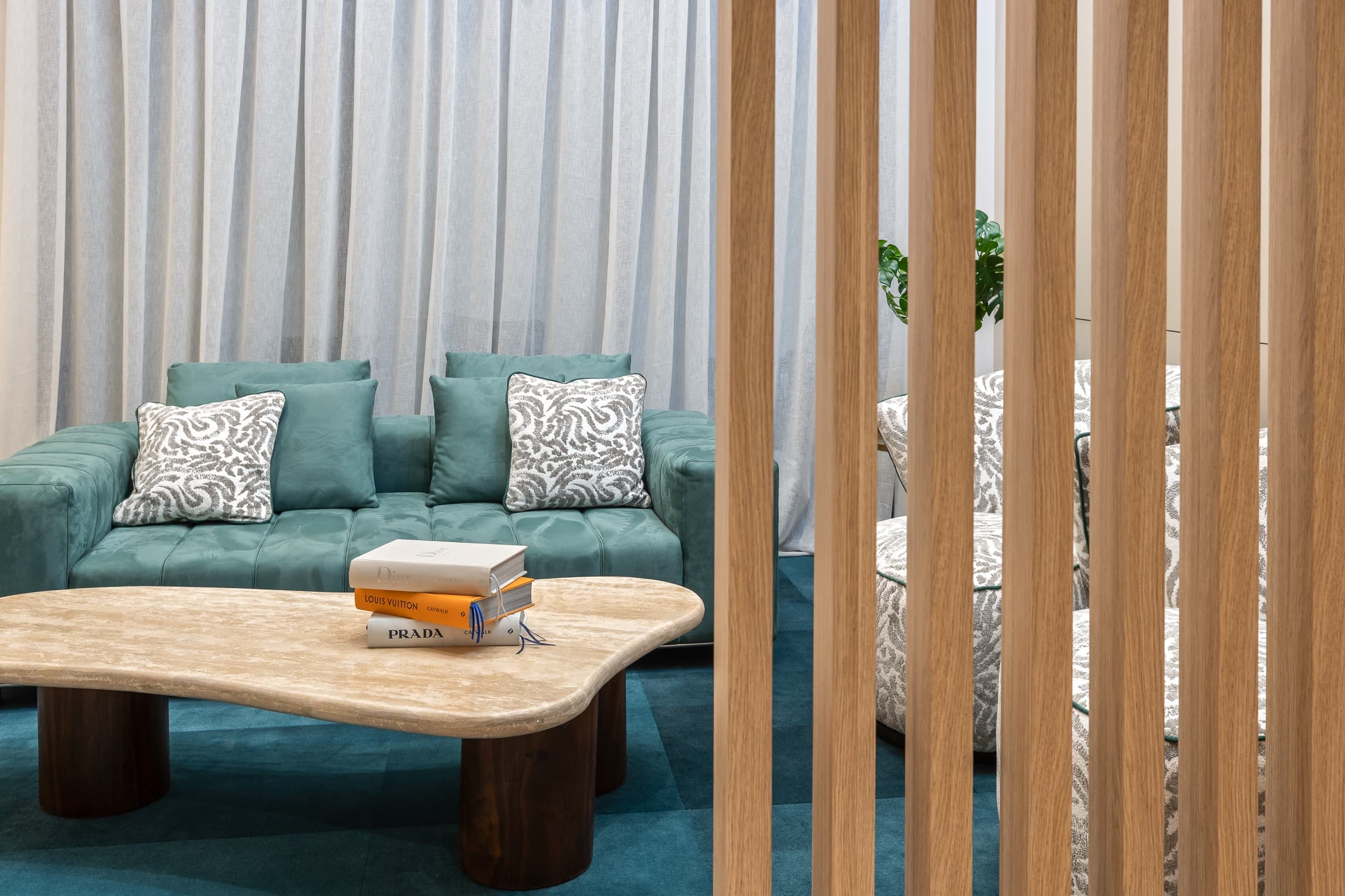 DNTL Code lounge with a green sofa and timber screens