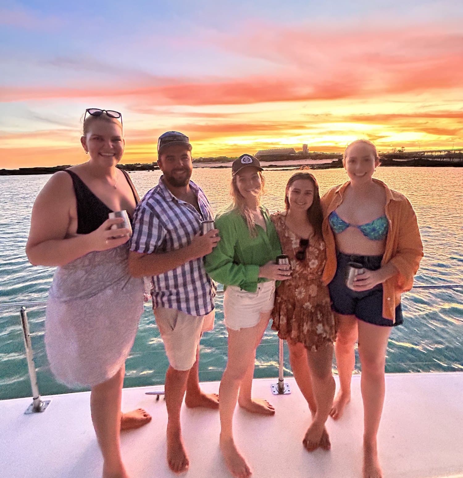 Friends on a boat at sunset
