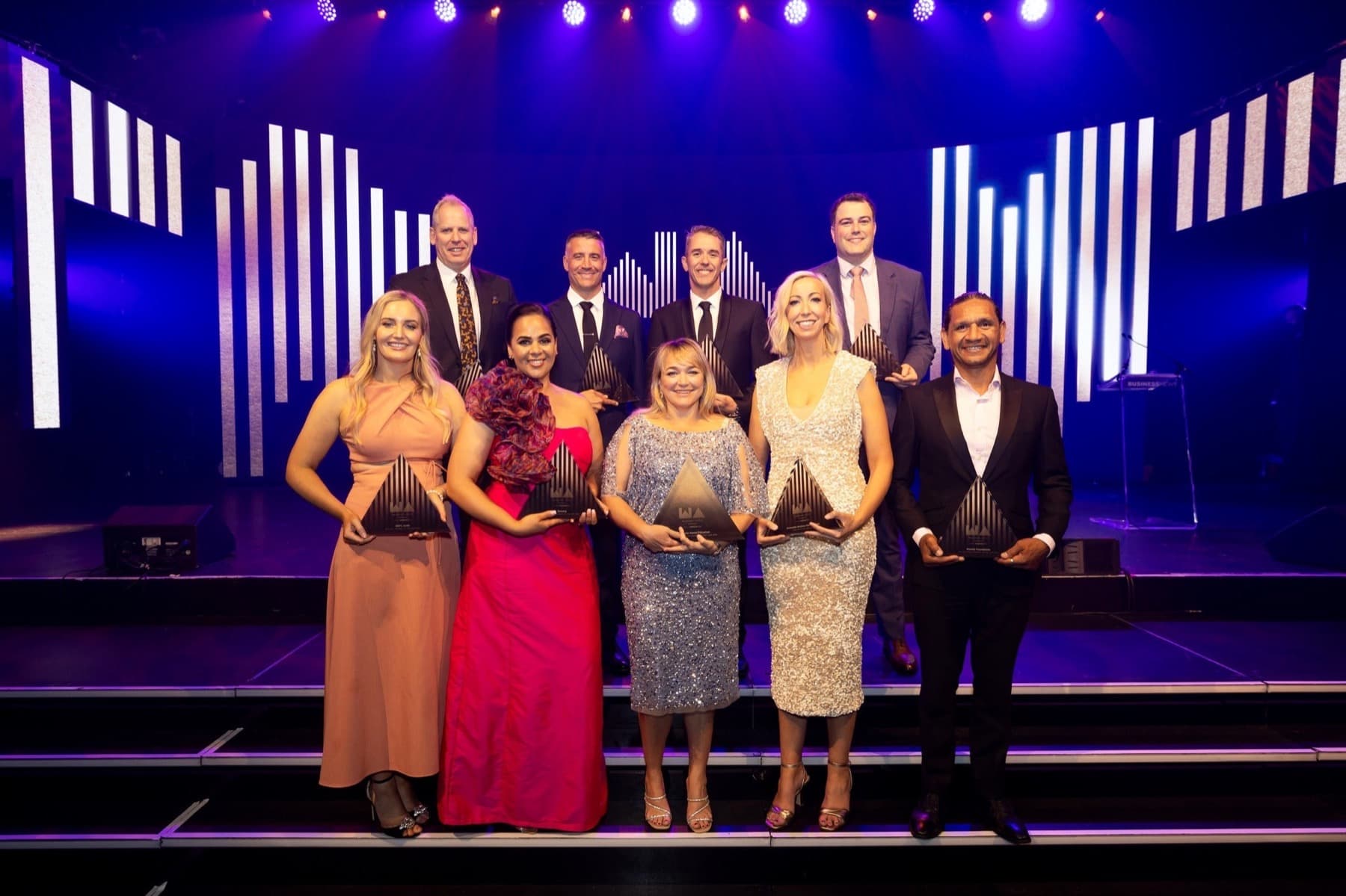 Award recipients on stage at an awards ceremony