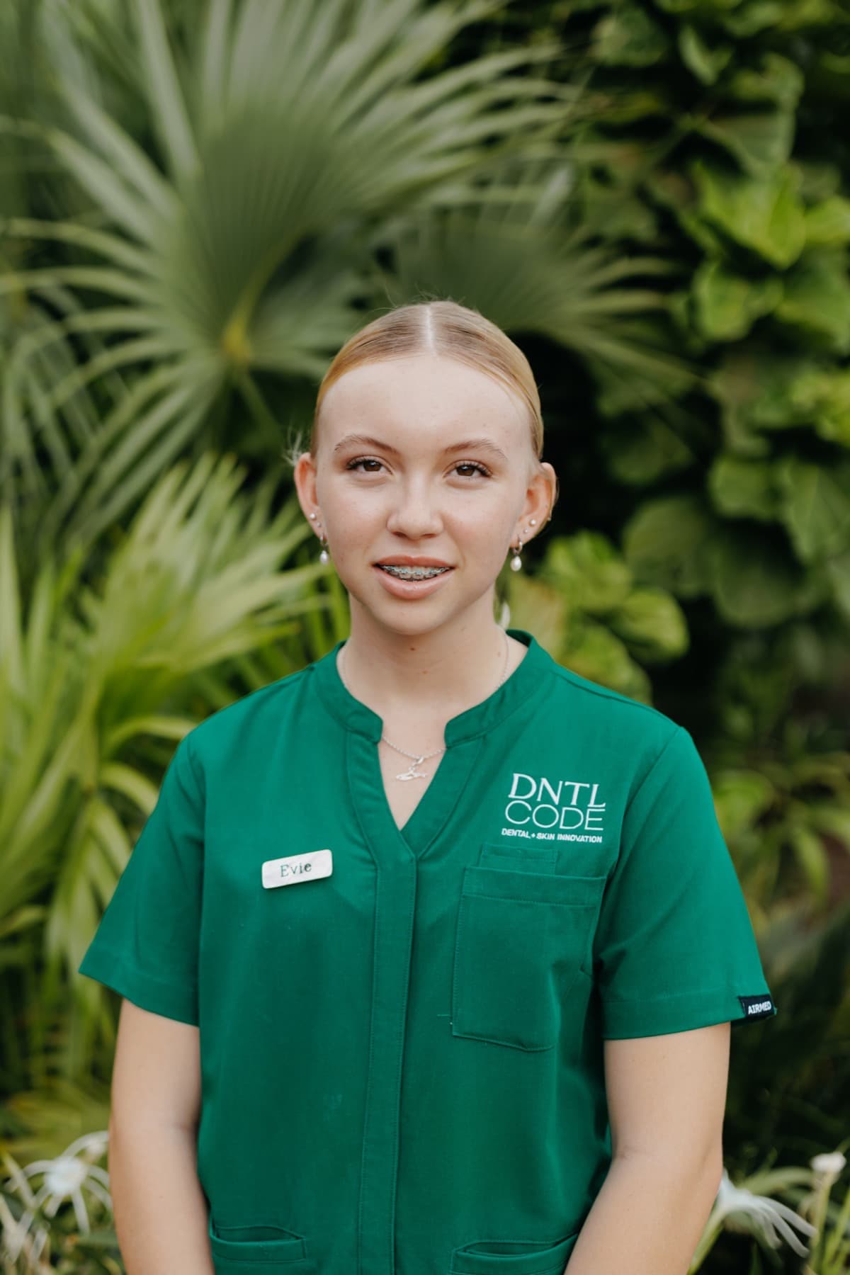 Young woman in DNTL Code scrubs