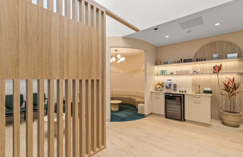 Clinic lounge with timber screen and retail shelving