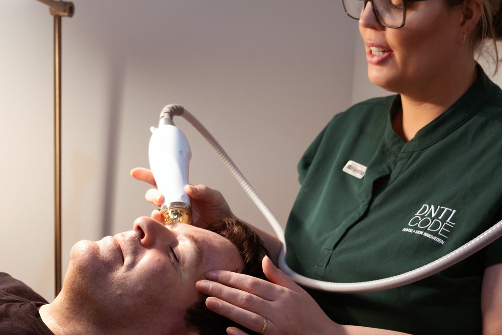 A man getting treatment of microneedling in dntl code clinic