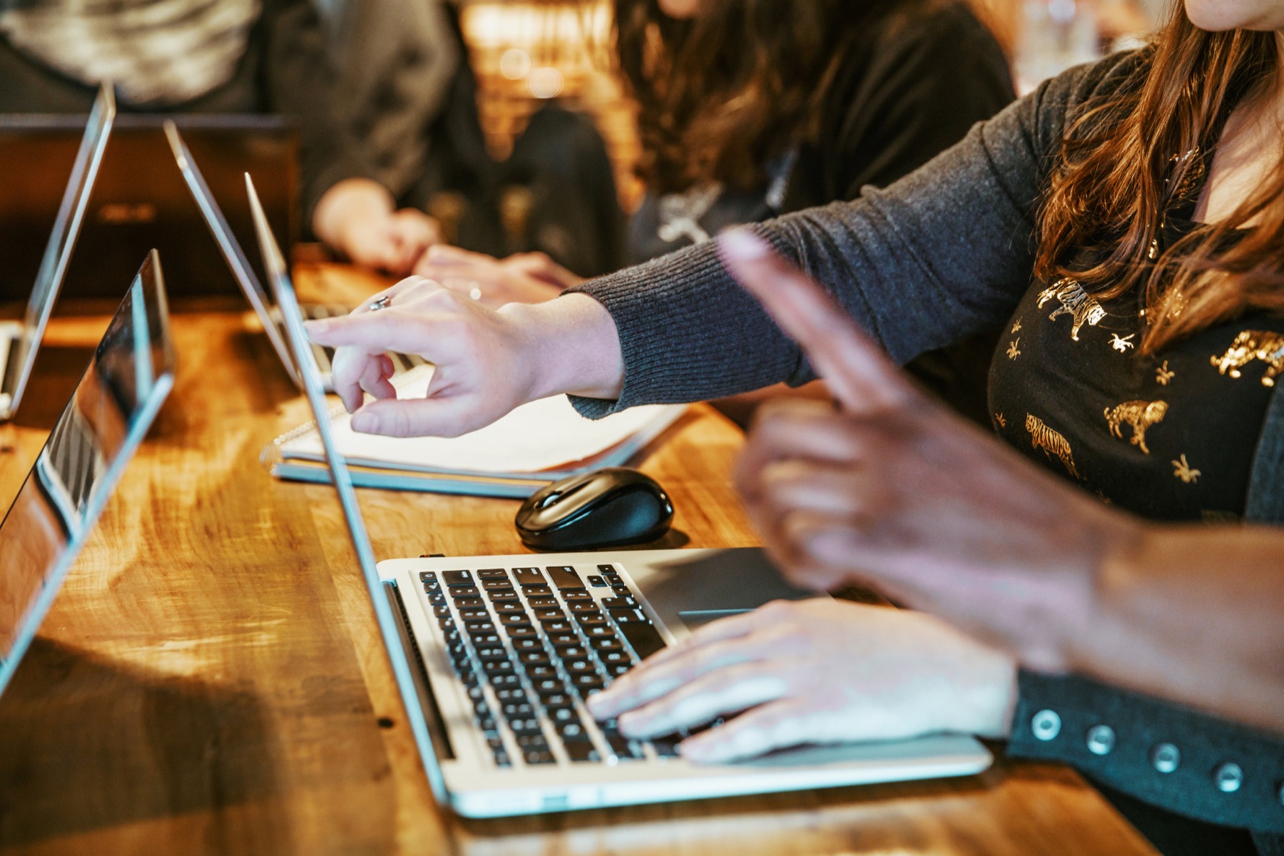 People working on laptops at a table