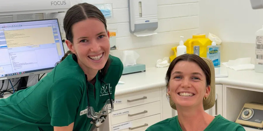 Two DNTL Code clinicians smiling in a treatment room