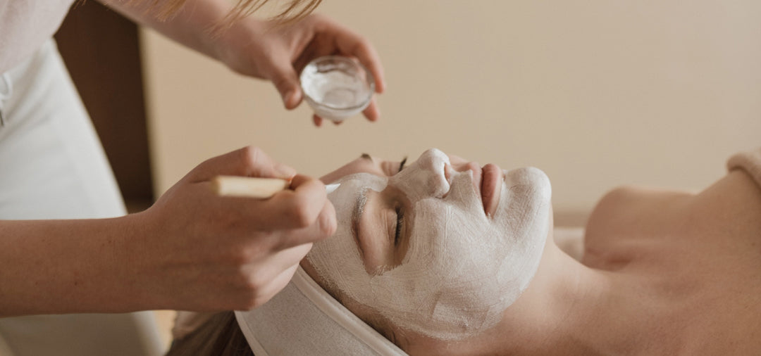 Peel mask being applied to a client’s face with a brush